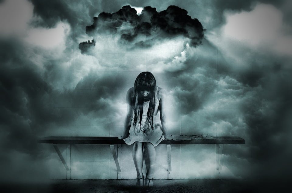 dark clouds over sad girl sitting bench